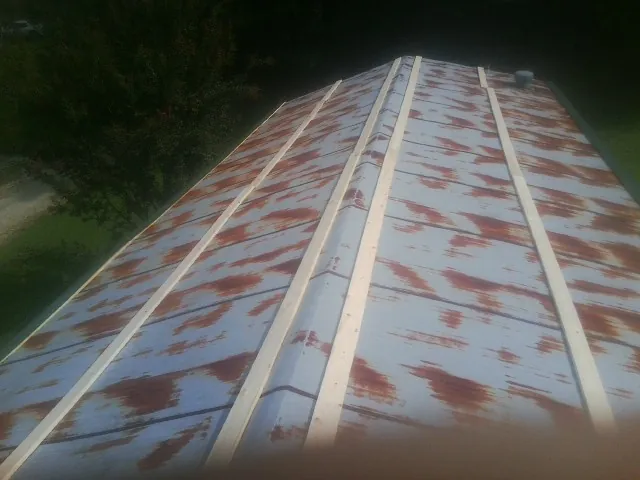 Rusted metal roof panels with new wood purlins before replacement — Storm Damage Roof Repair in Azusa by Roofing Brothers